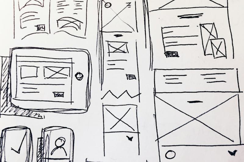 Website wireframe sketches on paper