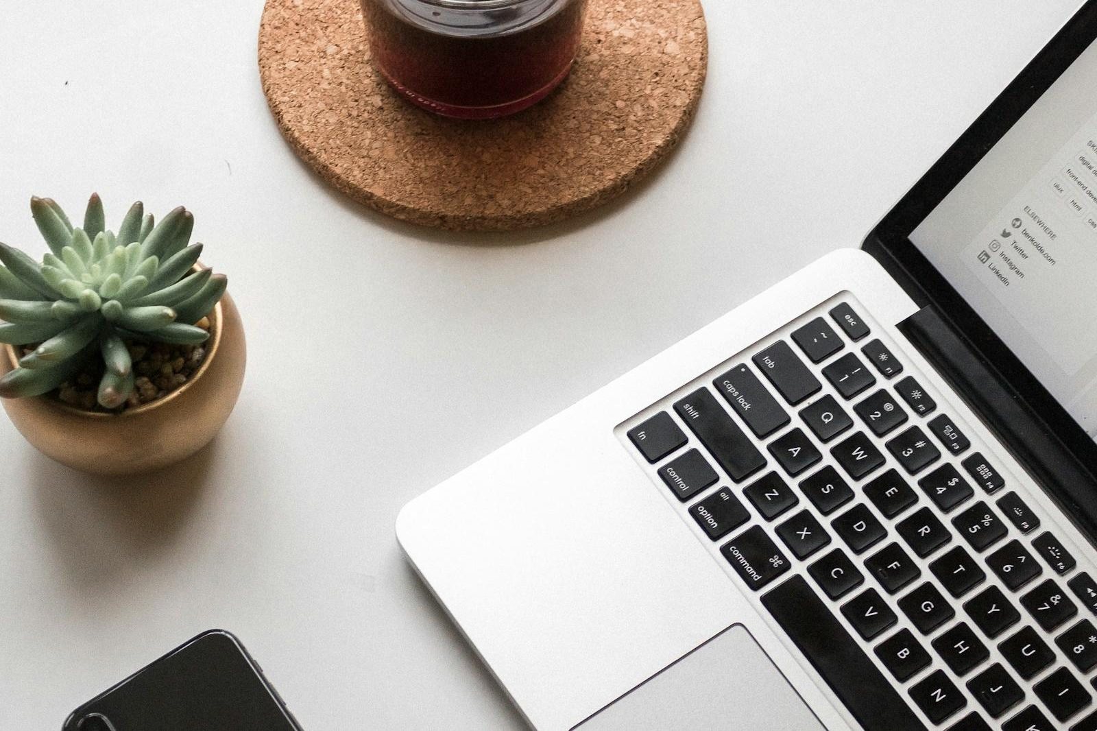 Laptop and notebook on a wooden desk